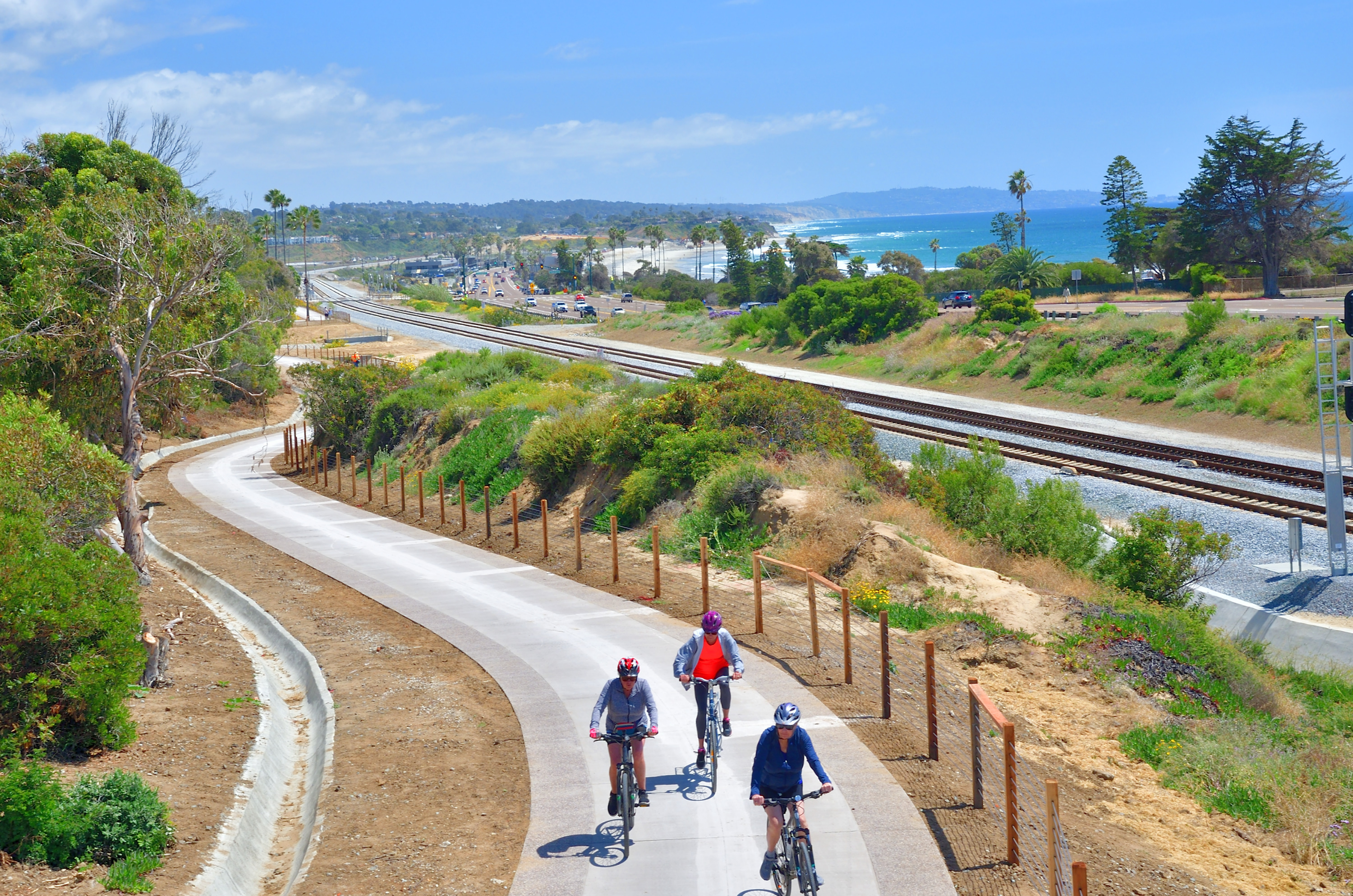Three people biking the Coastal Rail Trail in Encinitas